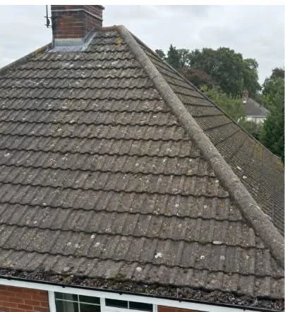 Weathered roof viewed along the ridge before replacement